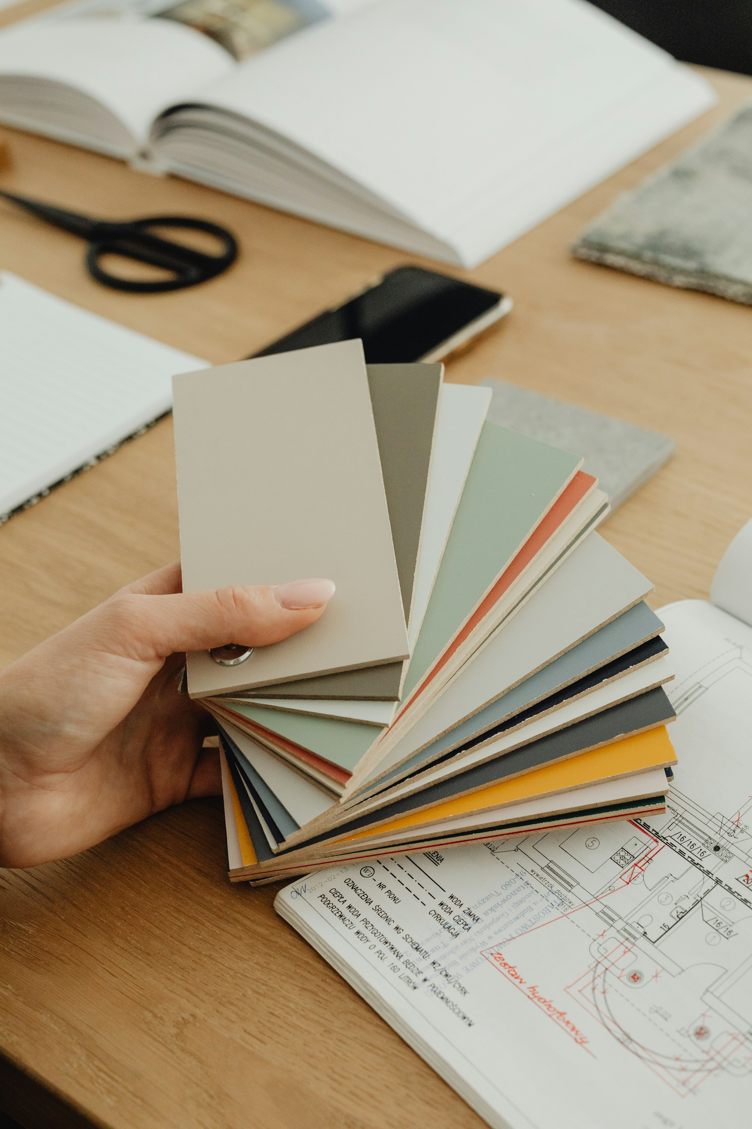Tape measure, floor plan sketch, or fabric samples on a table