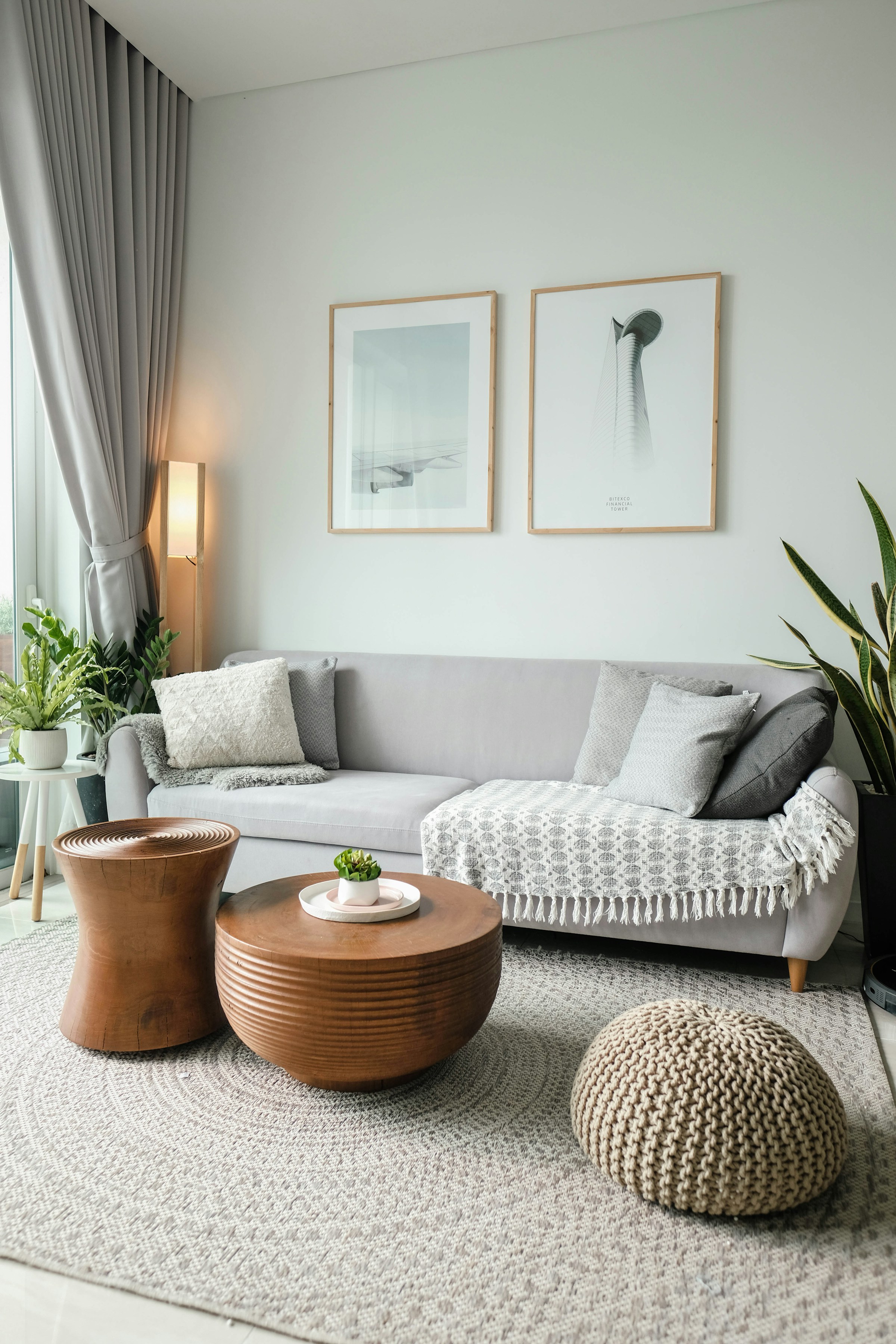 Warm modern living room: deep neutral sofa, warm wood, sculptural lamp