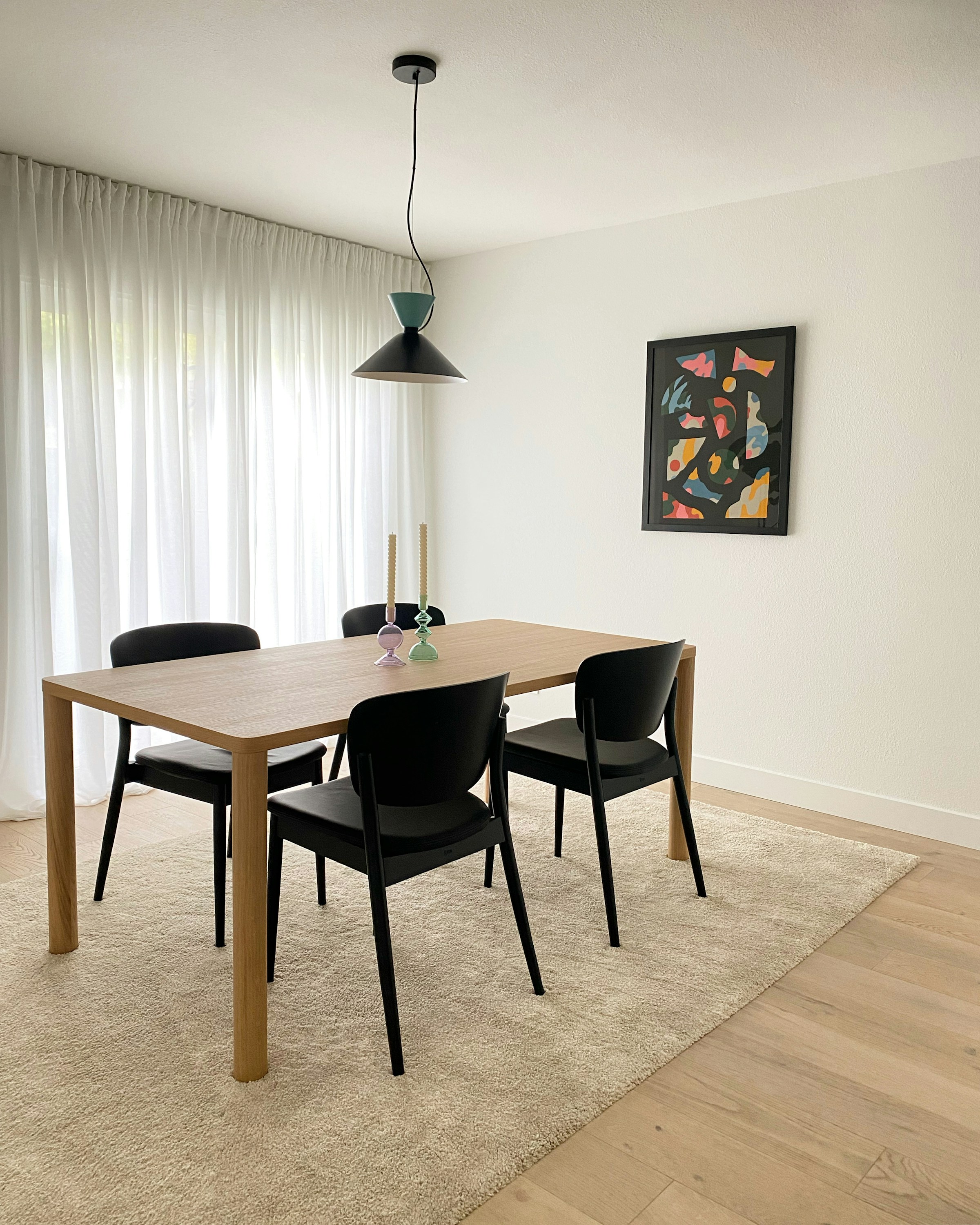 Compact dining room with a small table and light chairs
